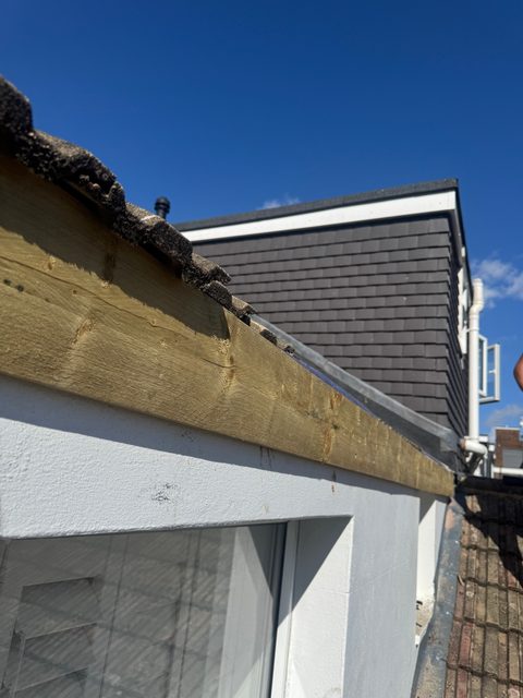 Storm Dry Roofing: new timber fascia board fitted along the edge of a flat-roofed extension