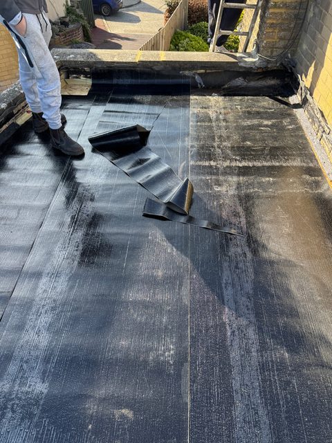 Storm Dry Roofing flat roof job: new felt base layer laid across the whole roof