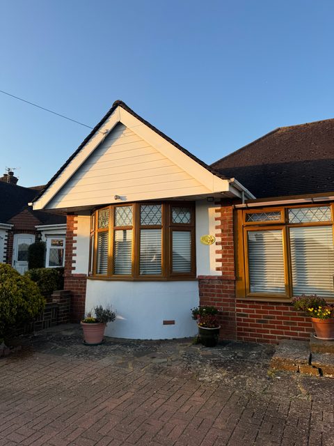 Storm Dry Roofing gable cladding job, after: the same bungalow gable clad in new uPVC with new fascias and soffit